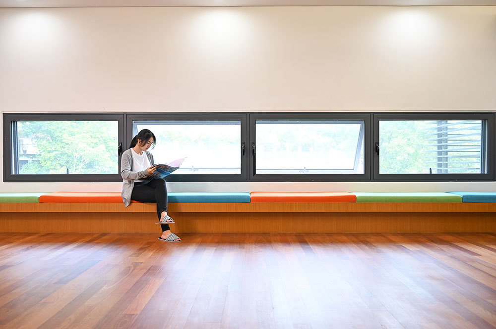 a girl sitting next to Arxtech security mesh casement window